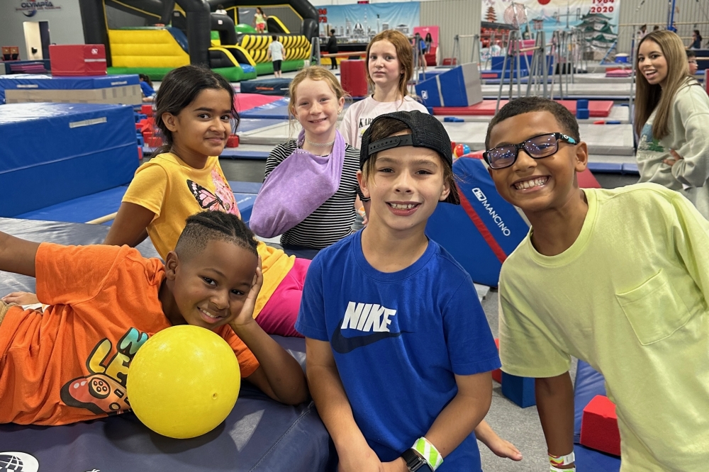 Campers at Olympia Gymnastics and Tumbling rotate through activity stations that include open gym, spots, outside activities, games and inflatables. (Courtesy Olympia Gymnastics and Tumbling)