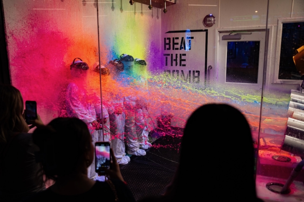 Beat the Bomb offers a gaming experience consisting of four to six players donning hazmat suits in order to solve codes that will help disarm an explosive paint bomb, foam bomb or slime bomb. (Courtesy Beat the Bomb)