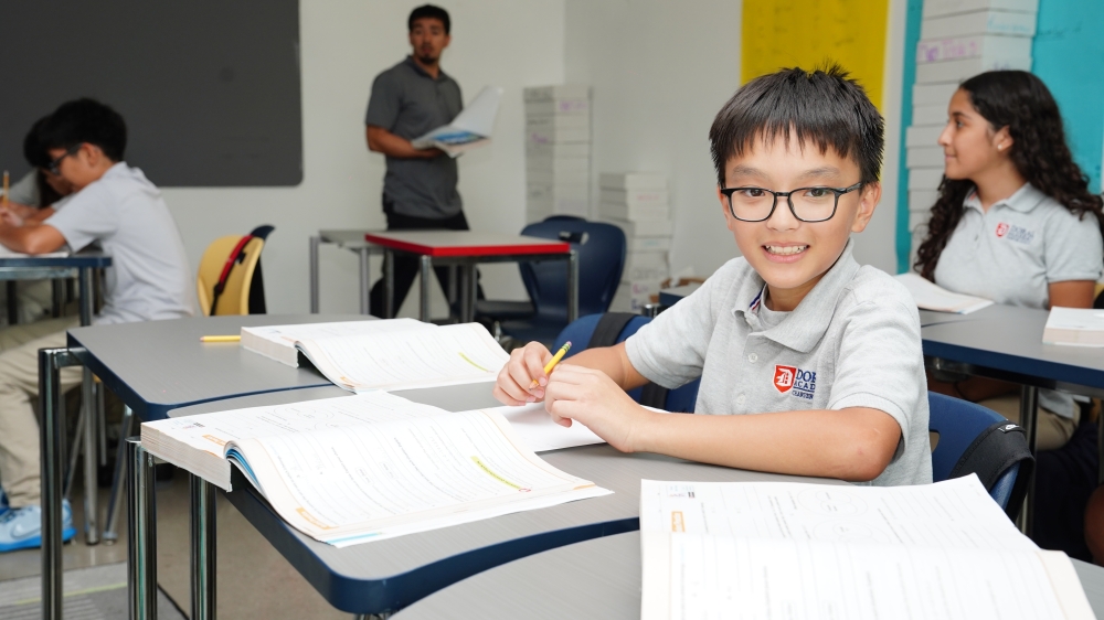 Student in elementary school STEM education class smiles