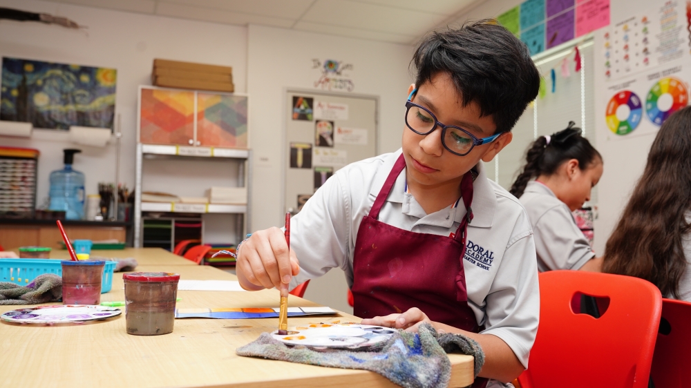 Student in Doral Academy of Texas' STEM program paints