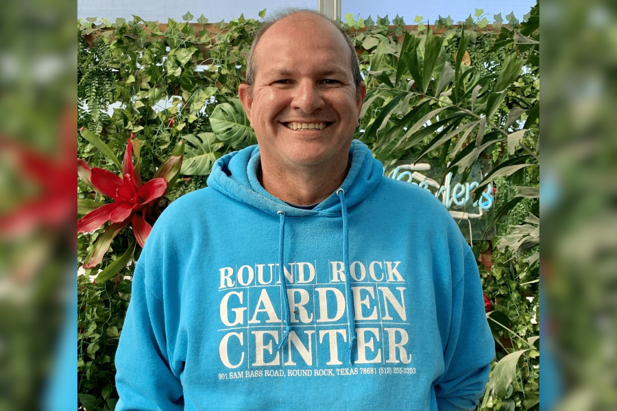 Round Rock Garden Center owner smiles in front of trees