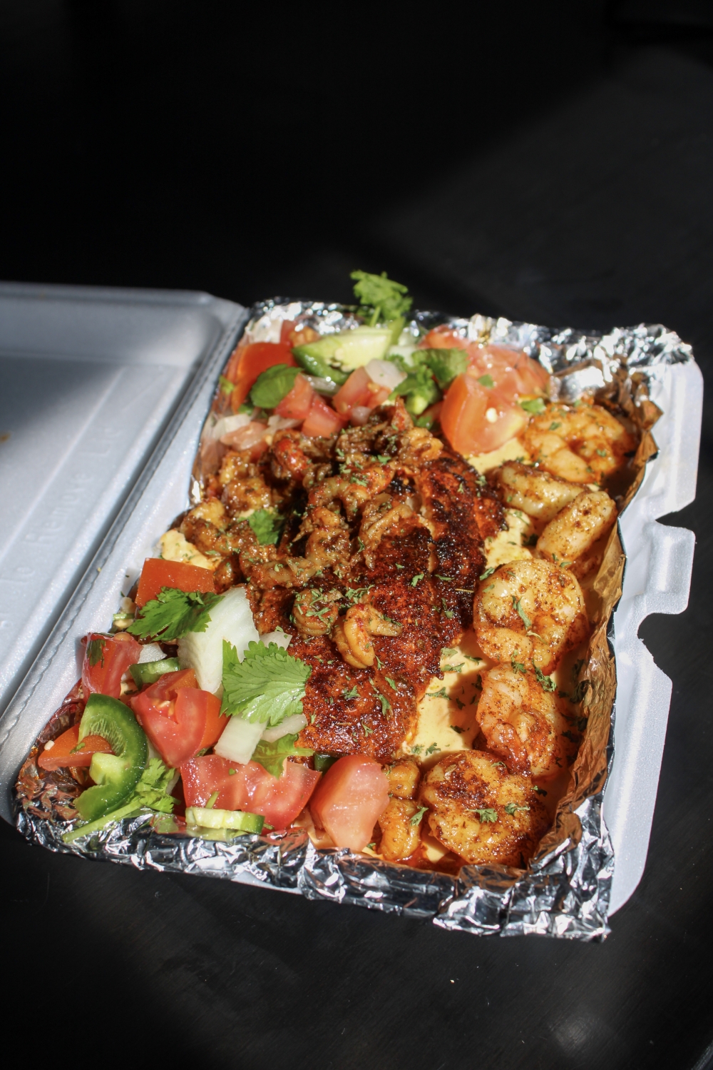 The restaurant offers weekly specials including Rec's Seafood Lover, a dish with rice, cajun sauce, pico de gallo, grilled shrimp, crawfish and blackened crawfish. (Dacia Garcia/Community Impact)