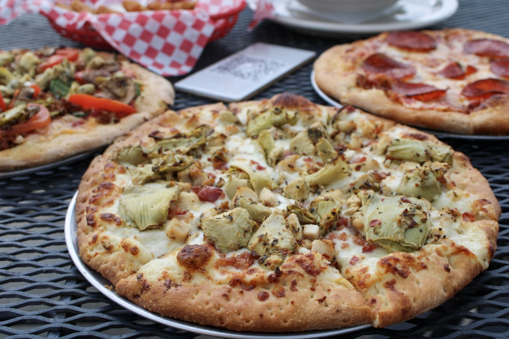 The Dude, $15-$20, is the most ordered pizza on the menu, according to general manager Robert Quayhagen. The pizza comes with parmesan white sauce, tender marinated chicken breast, crispy bacon and artichoke hearts. (Dacia Garcia/Community Impact)