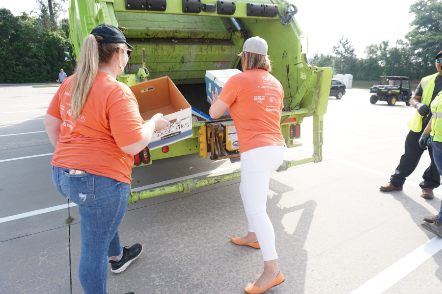 women recycle electronic device on recycling day in Tomball