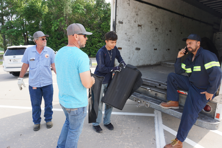 Men load recyclables into truck