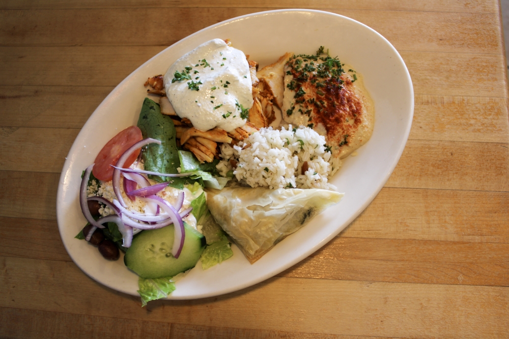 The Chicken Plate comes with thinly slices chicken topped with tzatziki sauce, two sides and a soup or salad, $13.50+. (Dacia Garcia/Community Impact)