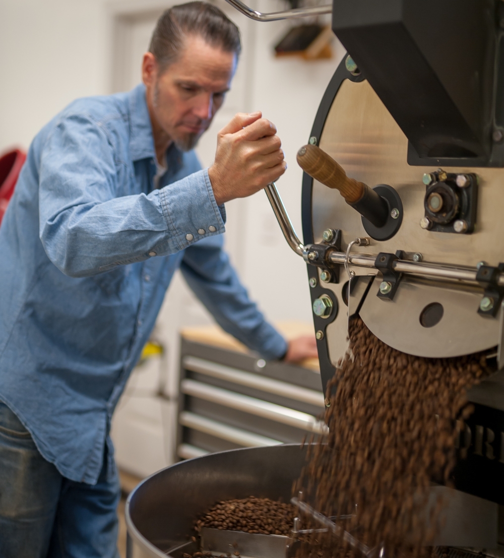 Wild Gift Coffee founder and co-owner Rob Ovitt uses one of the company's industrial-sized coffee roasting machines. (Courtesy Wild Gift Coffee)