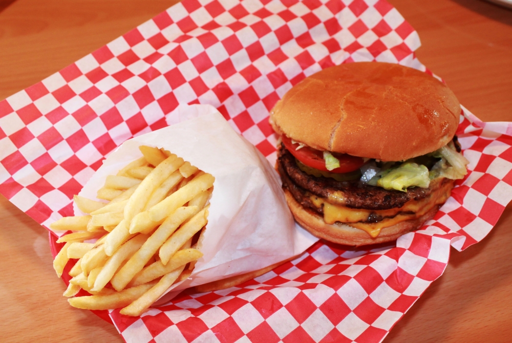 The Double Cheeseburger includes two beef patties on a toasted bun with lettuce, pickles, tomatoes, onions and mustard, $9.29. (Courtesy Pecan St. Station Deli & Grill)