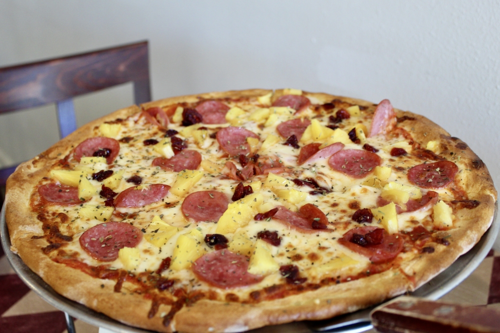 The Sweet Hawaii ($21.95) is made with Canadian bacon, dried cranberry, pineapple and mozzarella. (Jovanna Aguilar/Community Impact)