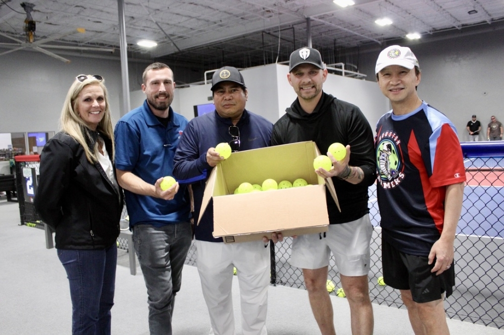 On March 18 Pickleball Country Club member Red Benzon donated a box of 50 pro-grade pickleballs to Camp Hope veterans. (Jovanna Aguilar/Community Impact)