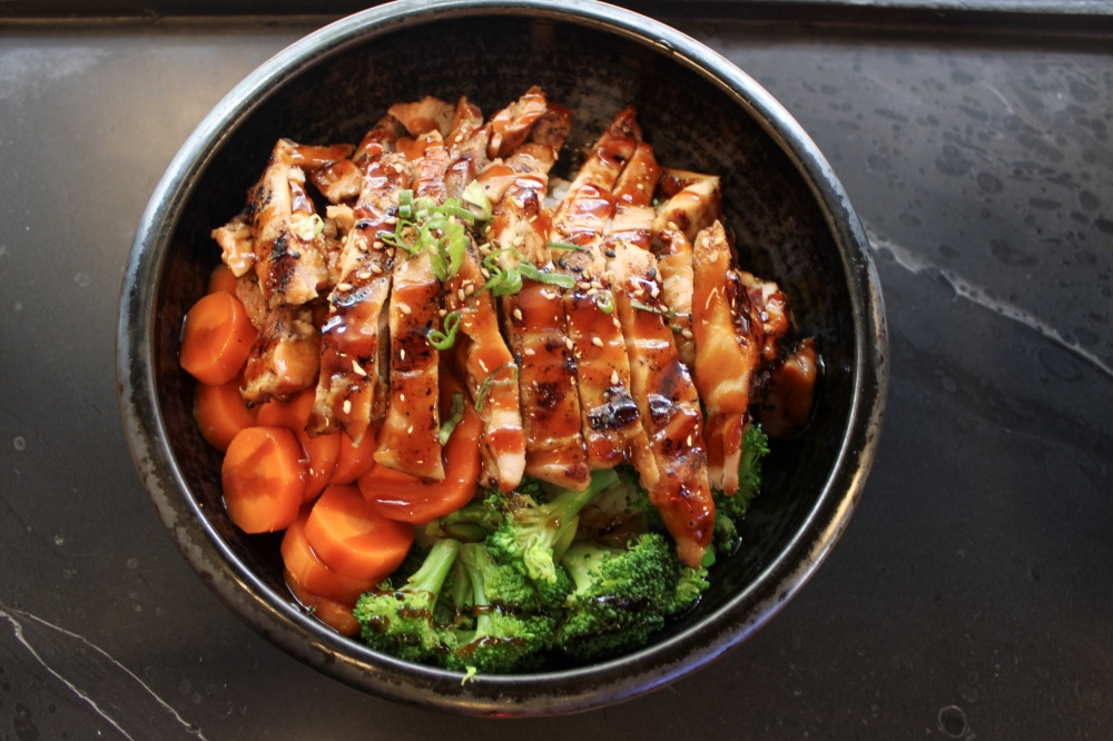 Pictured is the Teriyaki Chicken Bowl served with rice and steamed vegetables for $9.99. (Dacia Garcia/Community Impact)