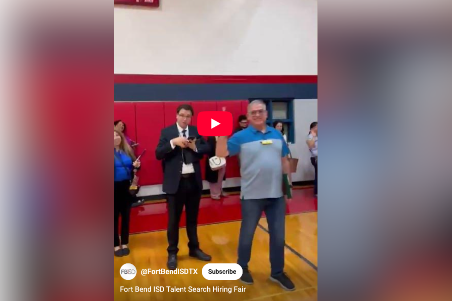 Administration at Fort Bend ISD speak to someone at a hiring fair for teaching and non-teaching positions 