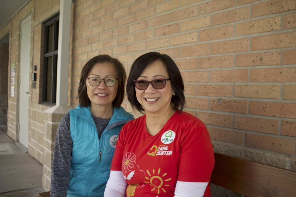 President Mei Wong (left) and Program Director Lily Shih sit outside Fort Bend Community Church after Fort Bend Care Center's April 8 food distribution event. (Kelly Schafler/Community Impact)