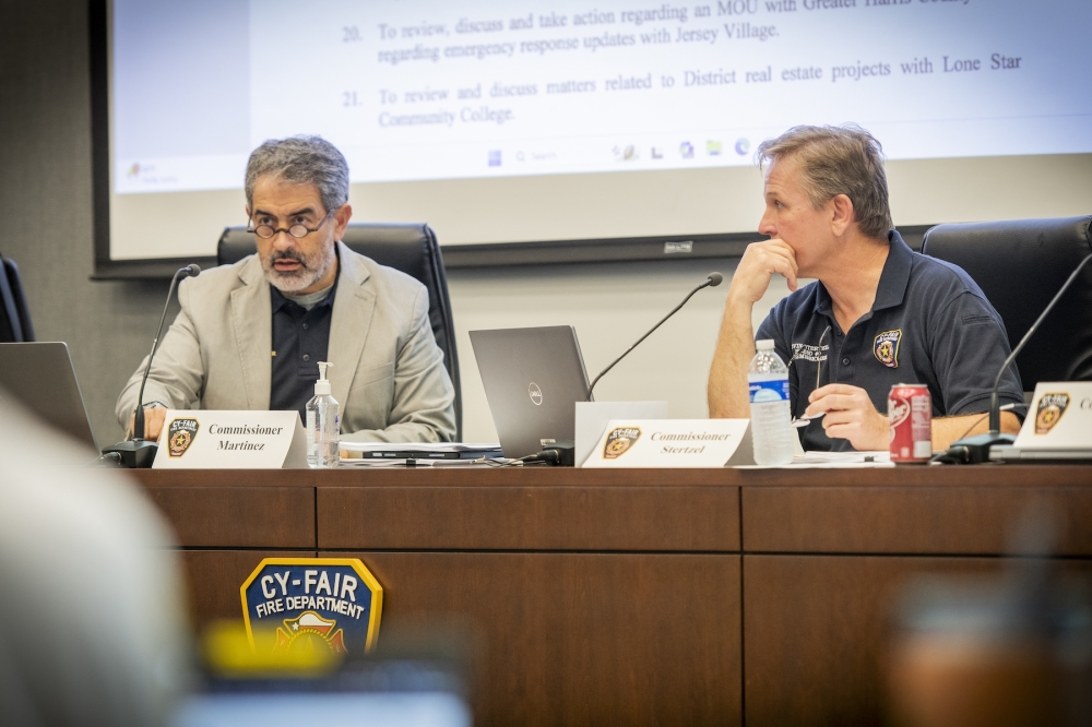 Commissioners Jaime Martinez, left, and Kevin Stertzel, right, participate in the Harris County ESD 9 board meeting April 24. (Courtesy Austin Miller/Apollo Productions)