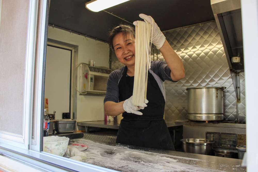 Owner Xue Mei Simard learned the hand stretching technique by taking courses in China. (Dacia Garcia/Community Impact)