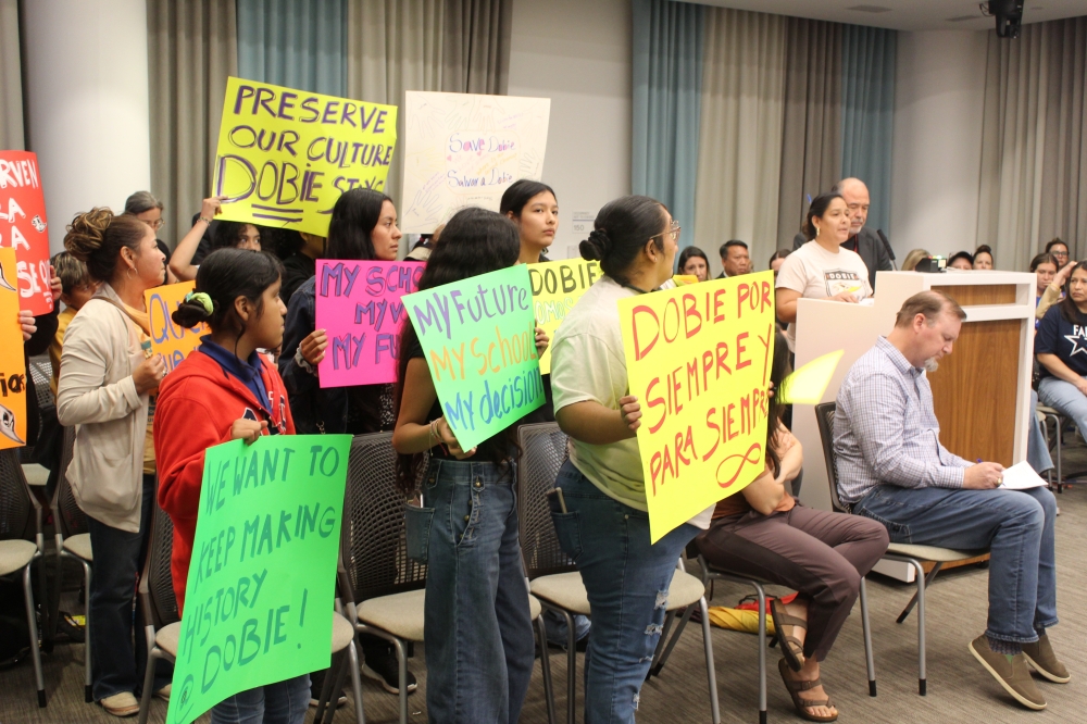 Community members urged the board to keep Dobie Middle School open at an April 24 board meeting. (Chloe Young/Community Impact)