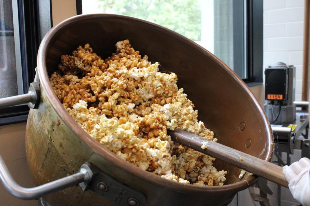 A small bag of Kilwins caramel corn ($5.99) is made by mixing housemade caramel with popcorn. (Anna Maness/Community Impact)