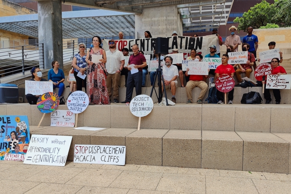 Community activists and Acacia Cliffs residents rallied at City Hall on May 8 to call for tenant protections ahead of the complex's proposed redevelopment. (Ben Thompson/Community Impact)