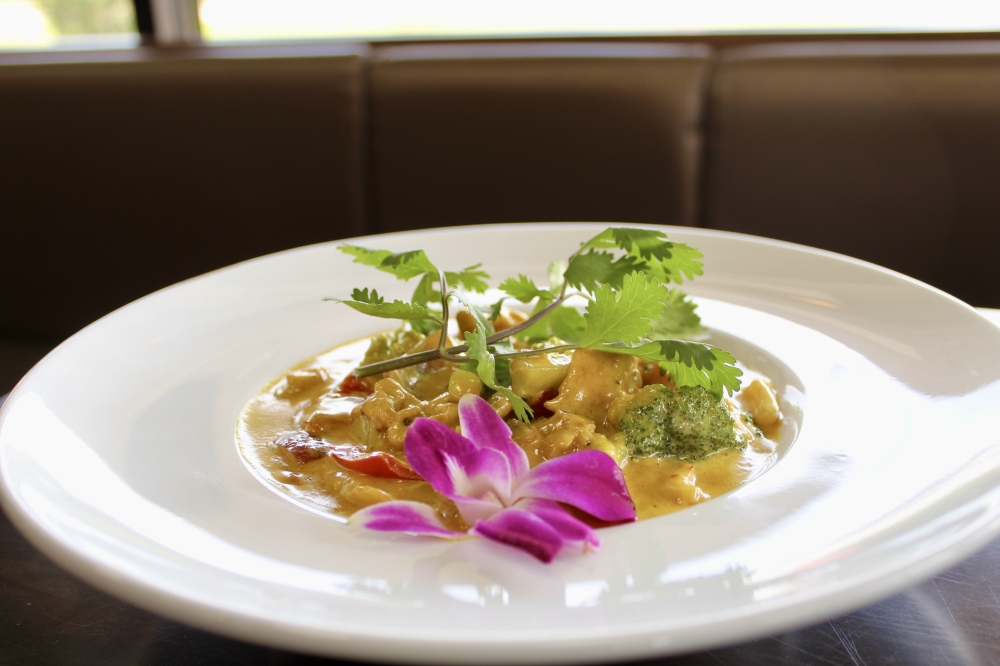 A restaurant staple is the chicken curry ($25), a family recipe with French influences made with lean chicken breast, stir fried with vegetables and homemade creamy yellow curry. (Jovanna Aguilar/Community Impact)
