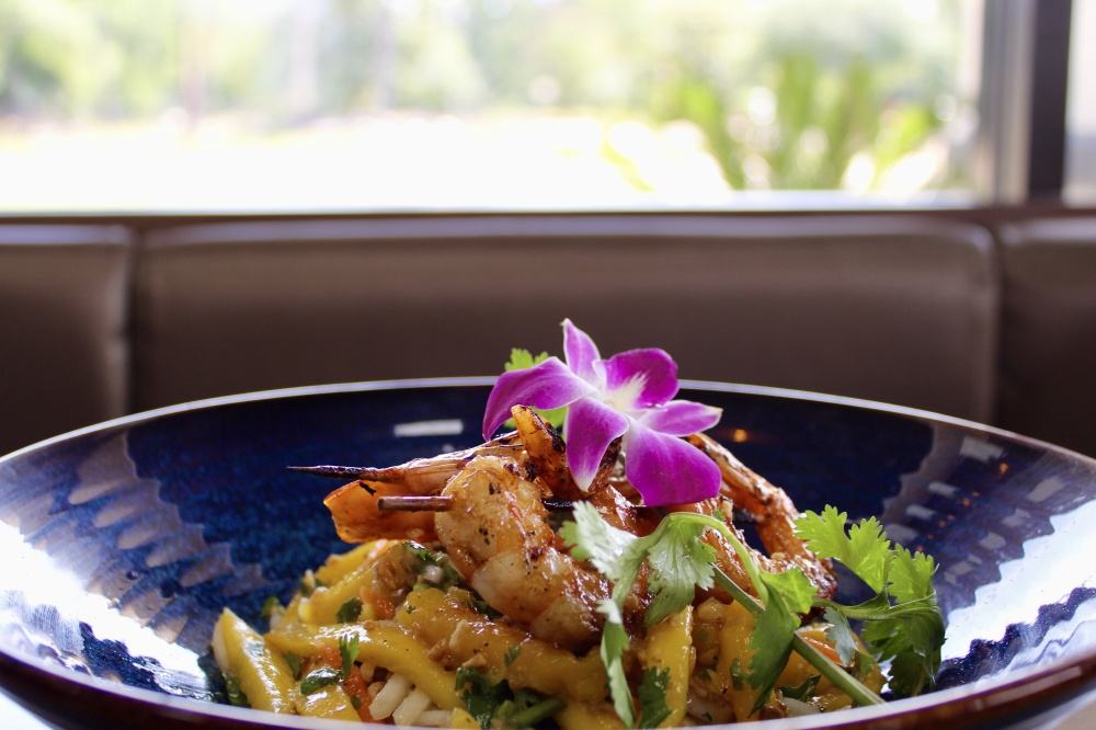 The mango salad ($15) is made with fresh mango, lightly pickled daikon, carrots, fresh herbs, roasted peanuts with tamarind dressing or a choice of grilled prawn, chicken or tofu. (Jovanna Aguilar/Community Impact)