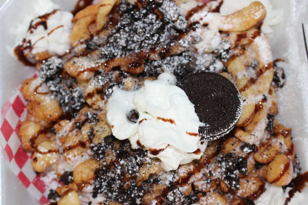 To keep the business thriving during cooler months, SnoDreamz Missouri City expanded its menu last February to include wings, fries, boudin balls tacos and funnel cakes. (Valeria Escobar/Community Impact)
