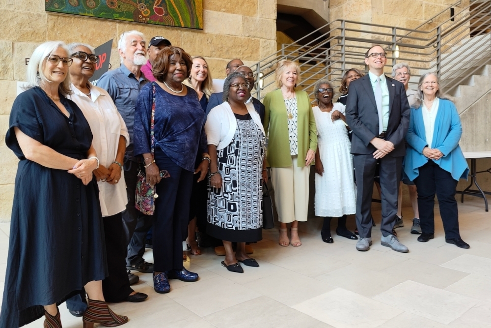 Residents and members of Don Baylor's family joined council member Marc Duchen, center right, after City Council approved the renaming of a West Austin park in Baylor's honor May 22. (Ben Thompson/Community Impact)