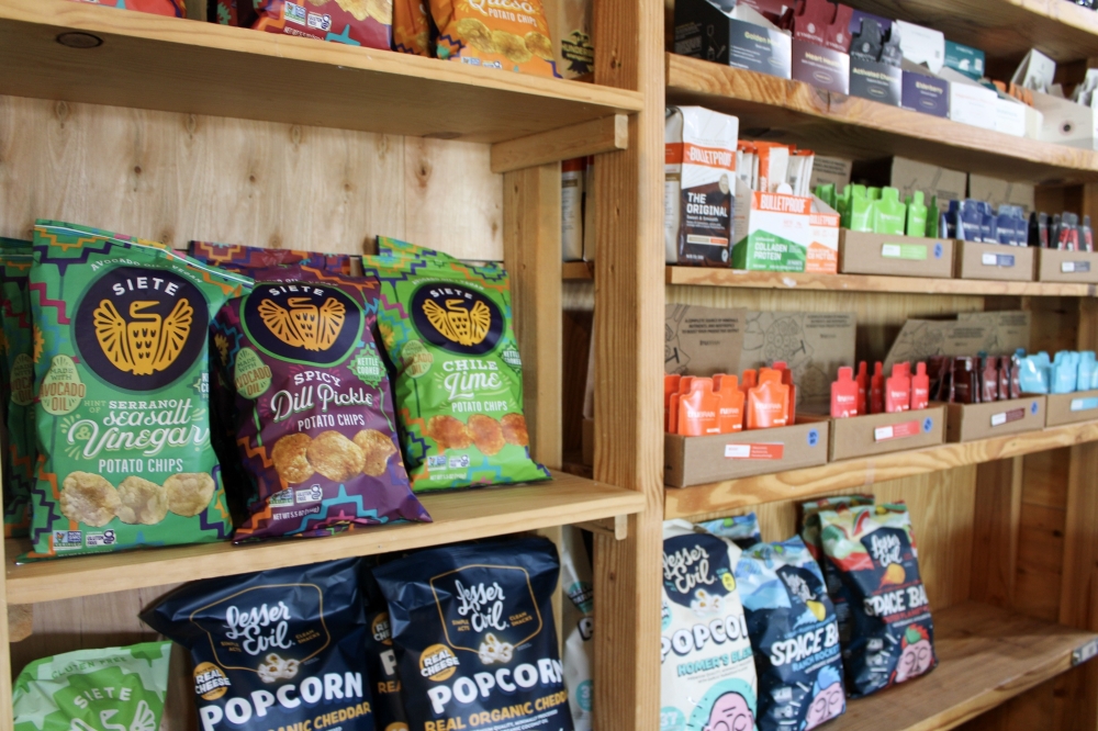 The business also sells healthy snack options including chips, protein bars, popcorn and more. (Dacia Garcia/Community Impact)
