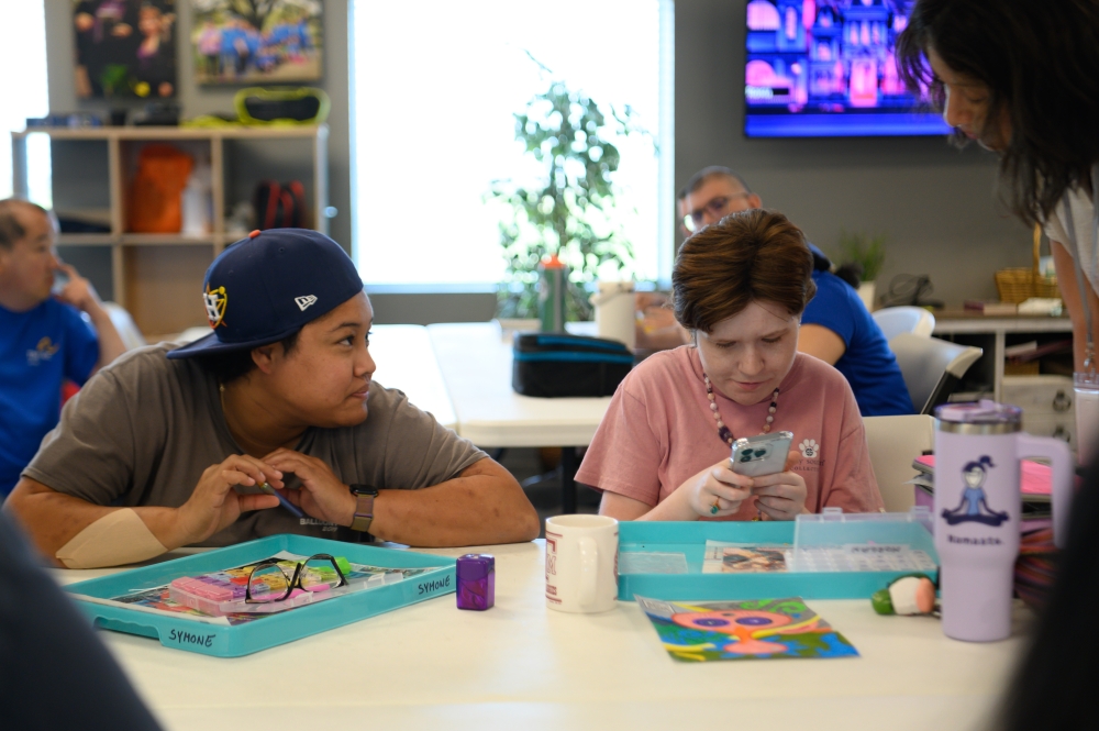 Caption: Morgan Fleckenstine (left) first recommended The Arc of Katy to Symone Velez’s (right) grandmother and soon after, Velez began attending. Since then, the two have built a close friendship, often connecting over FaceTime. Most recently, Velez said that it was Fleckenstine who encouraged her to join her for an Astros game. (Jamaal Ellis/Community Impact)
