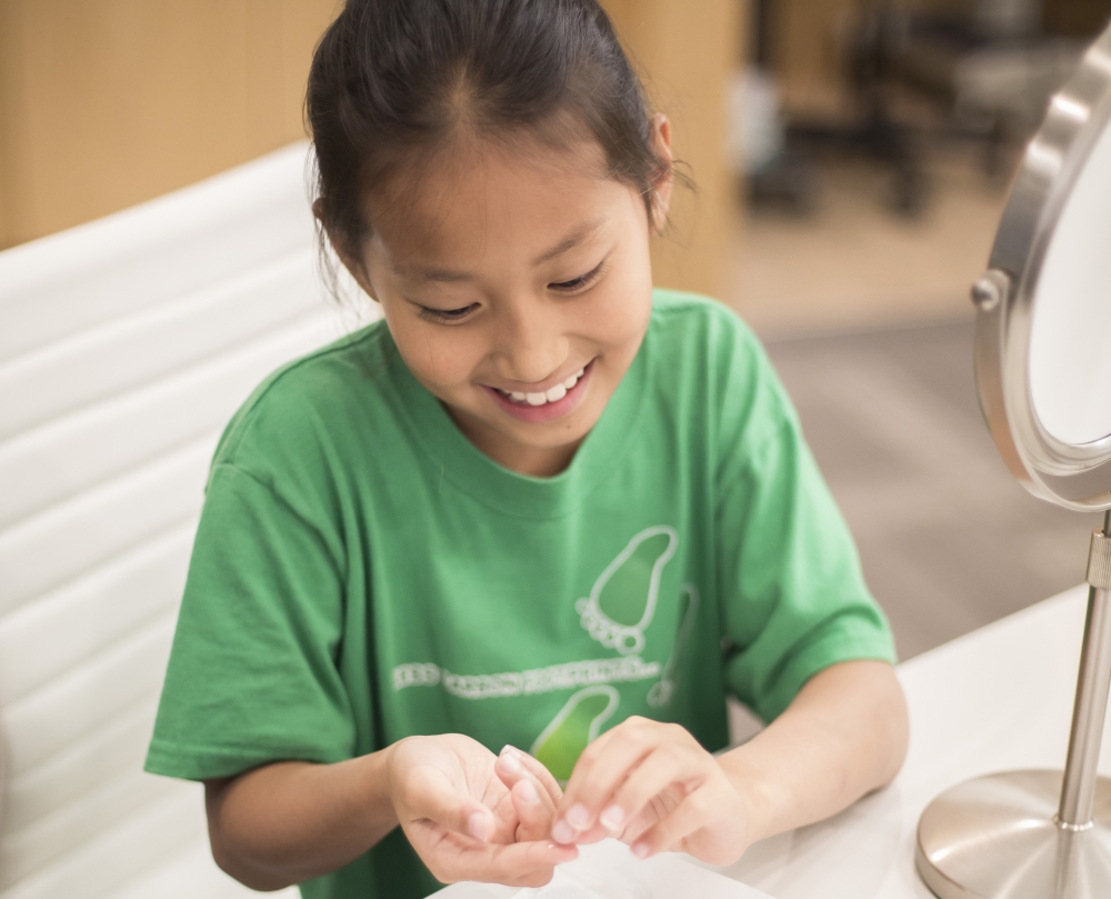 Child looking at a contact as part of myopia treatment for kids