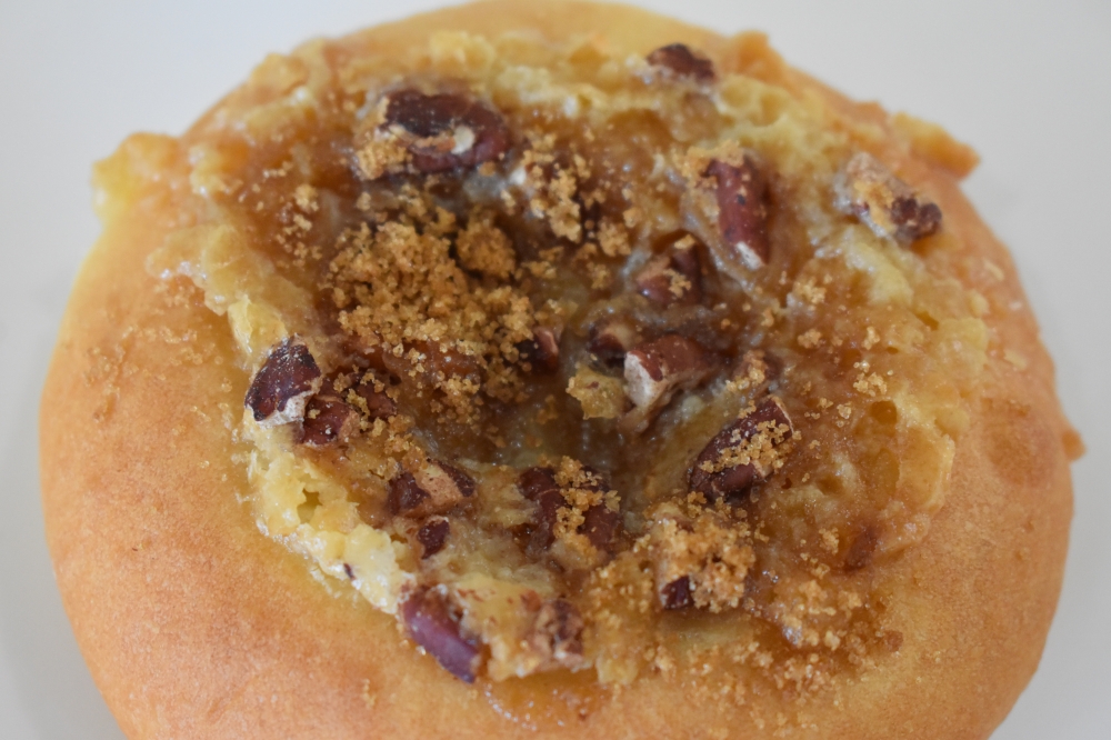 AllyAnne's Kolache Kitchen serves savory and sweet kolaches, including a maple pecan kolache ($2.50). AllyAnne said she makes the bread and the jam that fills the sweeter kolaches from scratch. (Julianna Washburn/Community Impact)