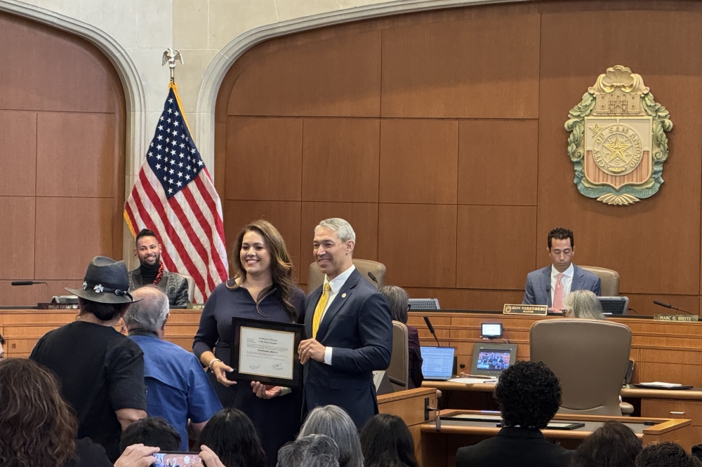 Former Mayor Ron Nirenberg presenting the certificate of election to District 8 council member Ivalis Meza Gonzalez. (Parks Kugle/Community Impact)