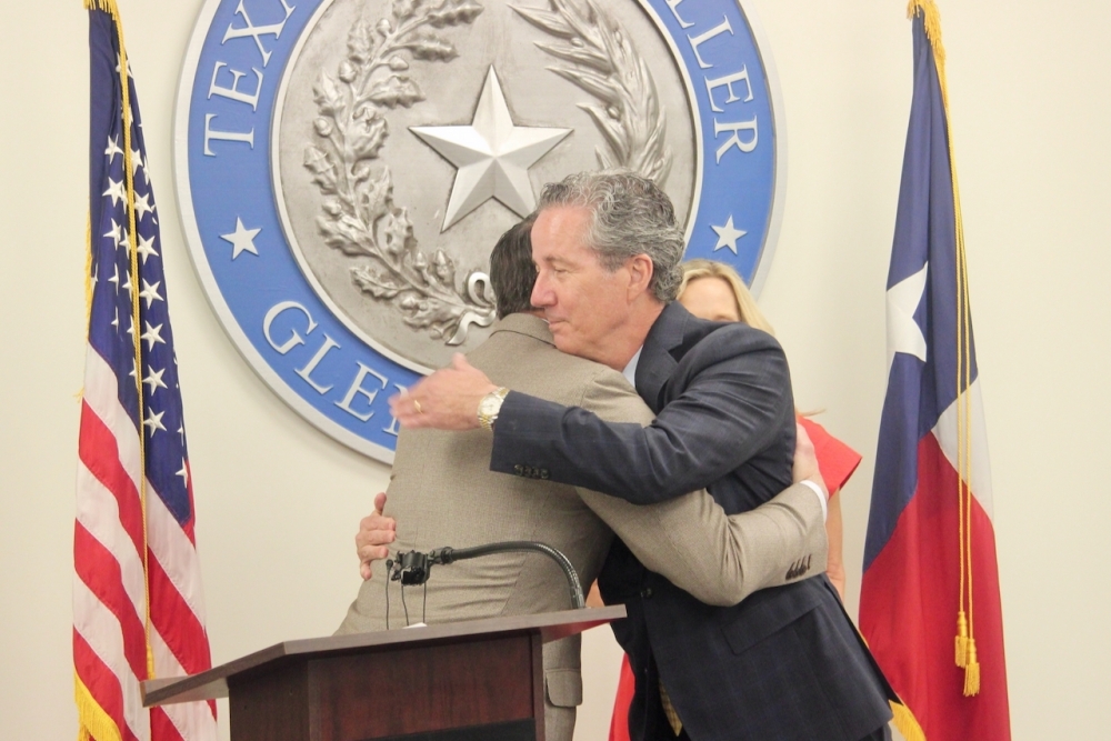 Texas Comptroller Glenn Hegar and state Sen. Kelly Hancock embraced after Hancock was sworn in to lead the comptroller's office on an acting basis. (Ben Thompson/Community Impact)