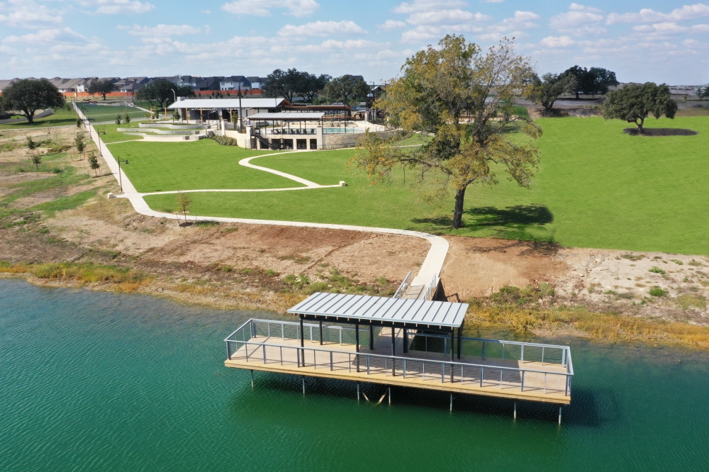 Fishing pond at a neighborhood with Liberty Hill homes