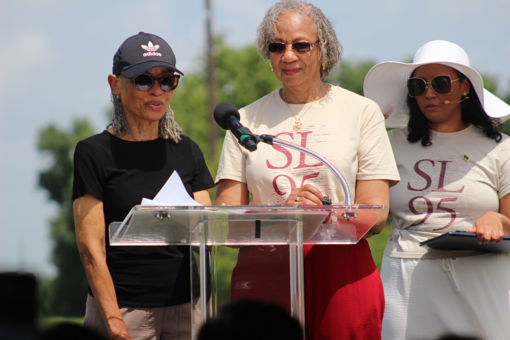 Sherra Aguirre (far left) and Jimmy Sue Davis (middle) are both descendants of a Sugar Land 95 member known as 'Marker 54.' (Valeria Escobar/Community Impact)
