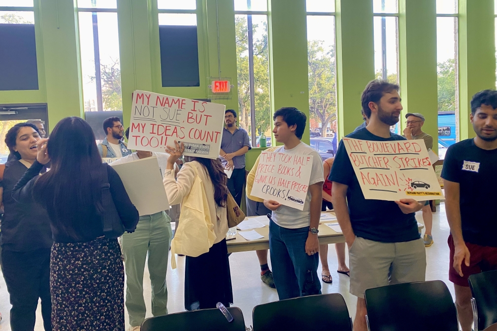 Protestors hold signs asking for the removal of Montrose TIRZ board member Matt Brollier, who was recently ousted for being influenced by former Houston Council member Sue Lovell to change road project requirements. (Cassandra Jenkins/Community Impact)