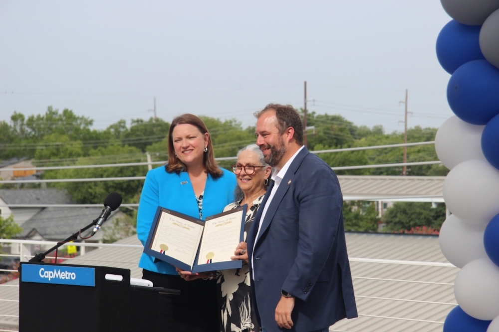 CapMetro President and CEO Dottie Watkins, left, accepted a proclamation recognizing the transit agency from state Reps. Lulu Flores and John Bucy. (Ben Thompson/Community Impact)