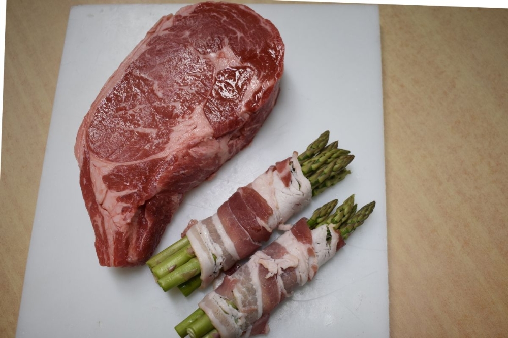The market’s offerings include prime ribeye ($29.99 per pound) with bacon-wrapped asparagus ($2.50 per pound). (Julianna Washburn/Community Impact)