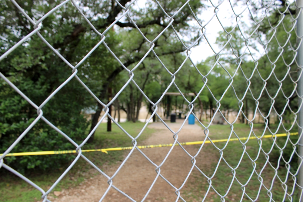 The entrance to Blue Hole Park near Pickett Trail and Blue Hole Park Road was blocked off to the public July 7. (Anna Maness/Community Impact)