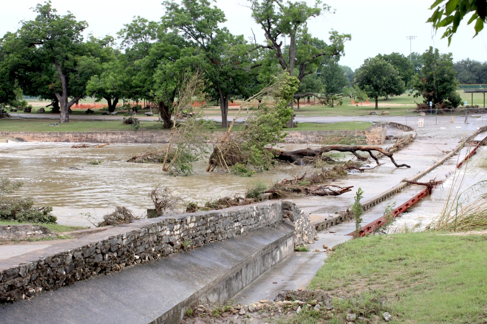 Trees washed up on the San Gabriel River Park Bridge near the Katy Crossing Trailhead at San Gabriel Park July 7. (Anna Maness/Community Impact)