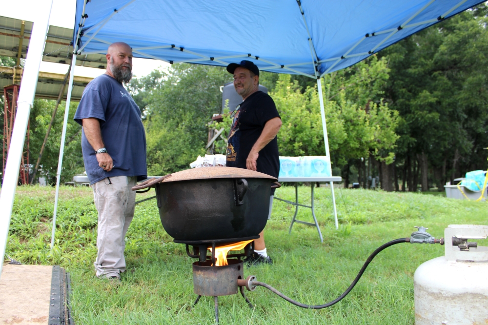 Jason Hale (left) with nonprofit Street Ministries 25:40 drove from Rockdale to Jonah the morning of July 7 to distribute food and water to residents in need. (Anna Maness/Community Impact)