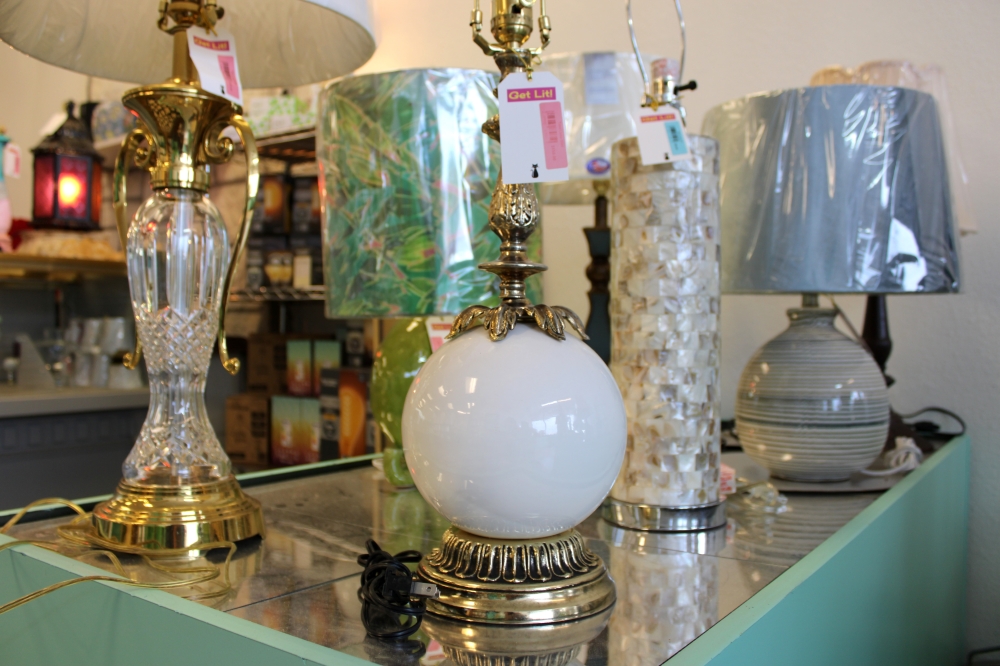 Gary McNabb said he often creates lamps by piecing together parts from different items, like with this gold and white lamp. (Anna Maness/Community Impact)
