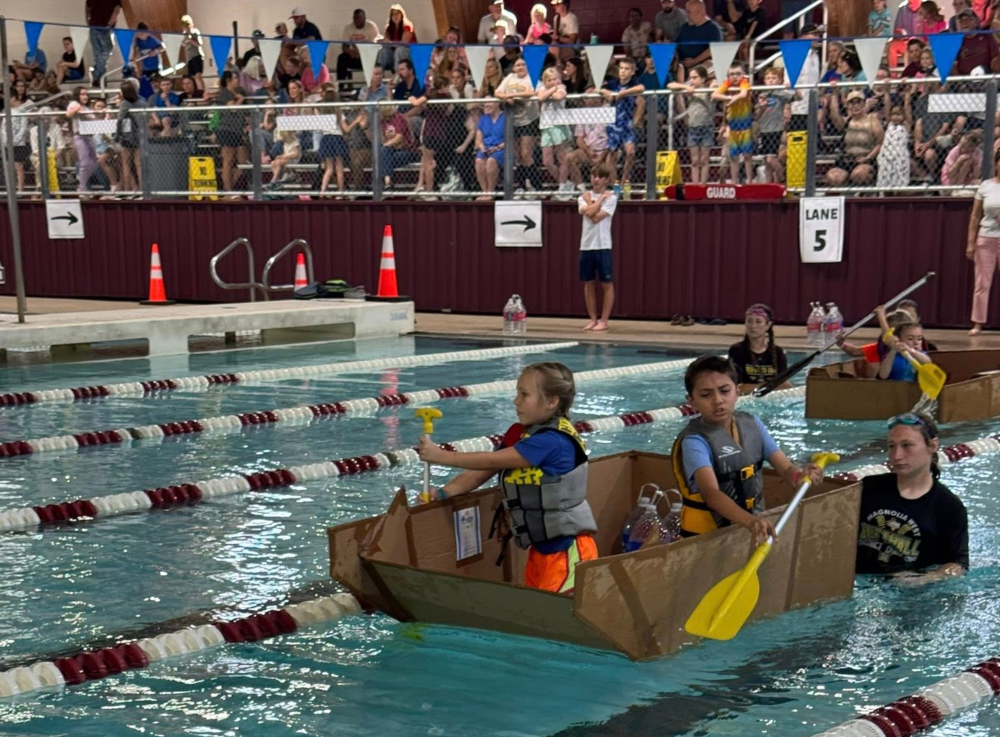 Magnolia ISD students on homemade boat for school project