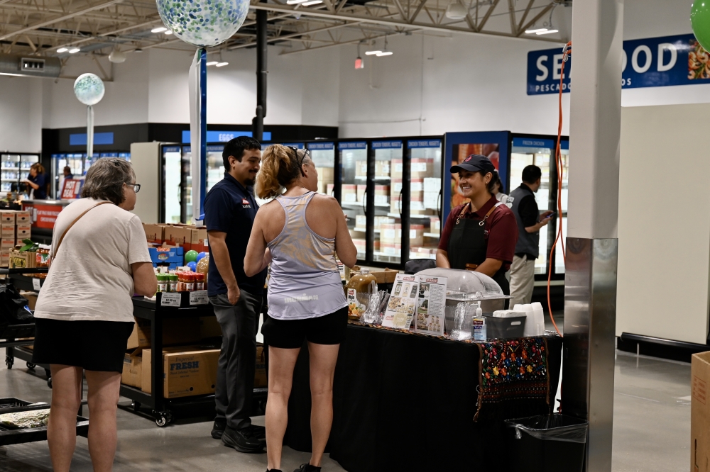 Sysco partners and distributors set up tables to pass out and advertise samples at the ribbon-cutting ceremony. (Roo Moody/Community Impact)
