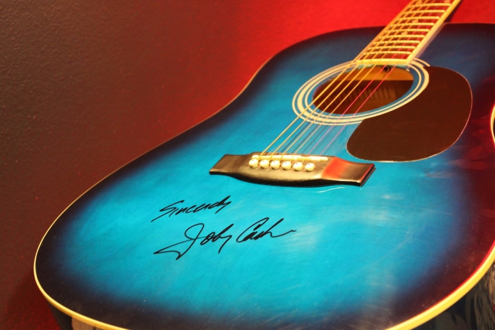 The Guitar Bar features signed guitars from many famous artists, such as this acoustic guitar that was signed by Johnny Cash. (Andrew Creelman/Community Impact)