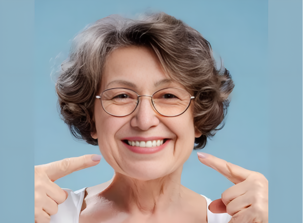 Dental patient smiling while pointing at teeth