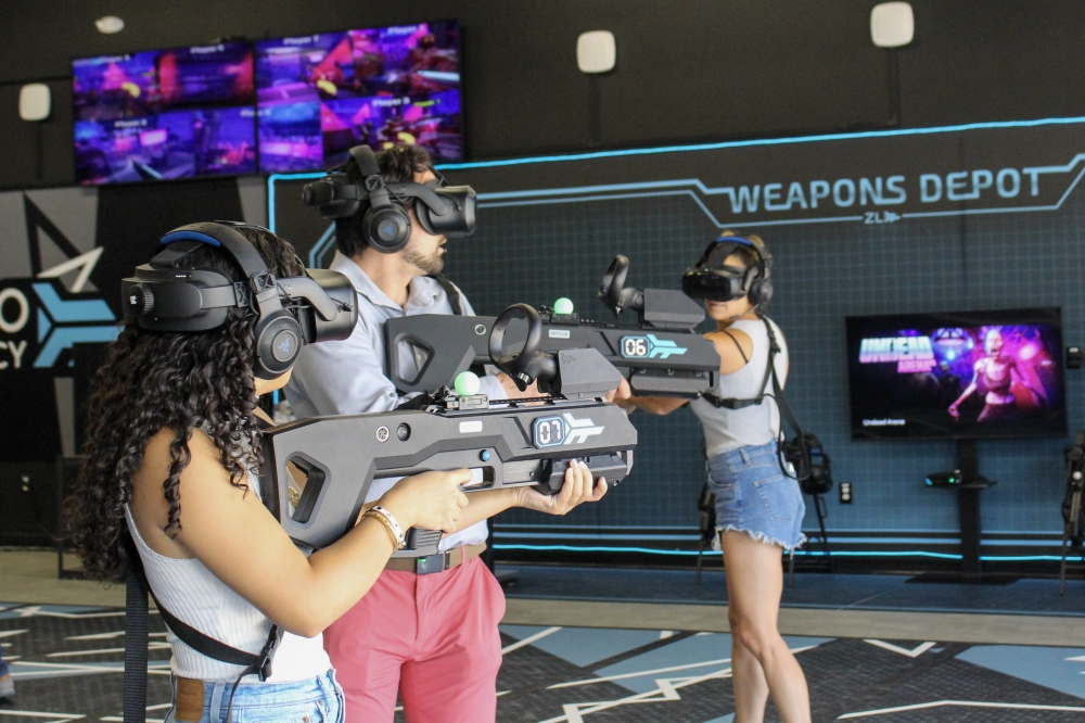 Members of the Austin Chamber of Commerce tried their hand at a virtual reality zombie battle game during a ribbon cutting event July 31 for Zero Latency VR Austin. (Elisabeth Jimenez/Community Impact)
