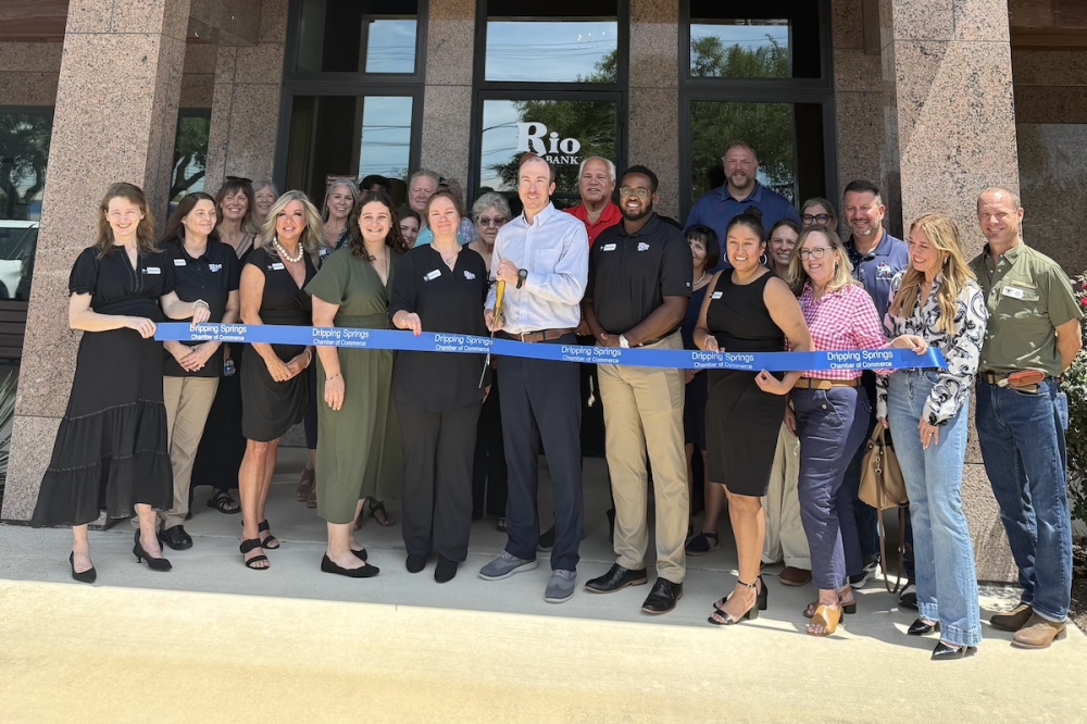 The Dripping Springs Chamber of Commerce and Rio Bank held a ribbon cutting July 22 to mark Rio Bank's takeover of Lone Star Capital Bank, which includes a location in Dripping Springs. (Judy LeBas/Community Impact)