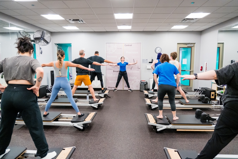 Participants balancing in San Antonio Pilates class