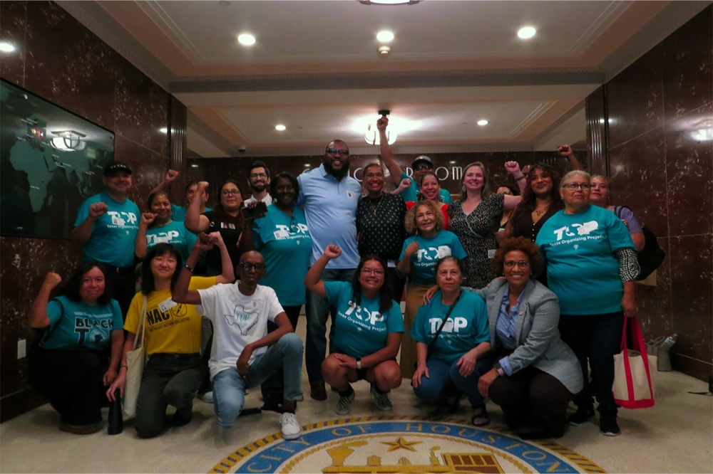 The Northeast Action Collective and Texas Organizing Project in front of City Council Chambers after the passing of federal aid disaster funds. (Kevin Vu/Community Impact Newspaper)
