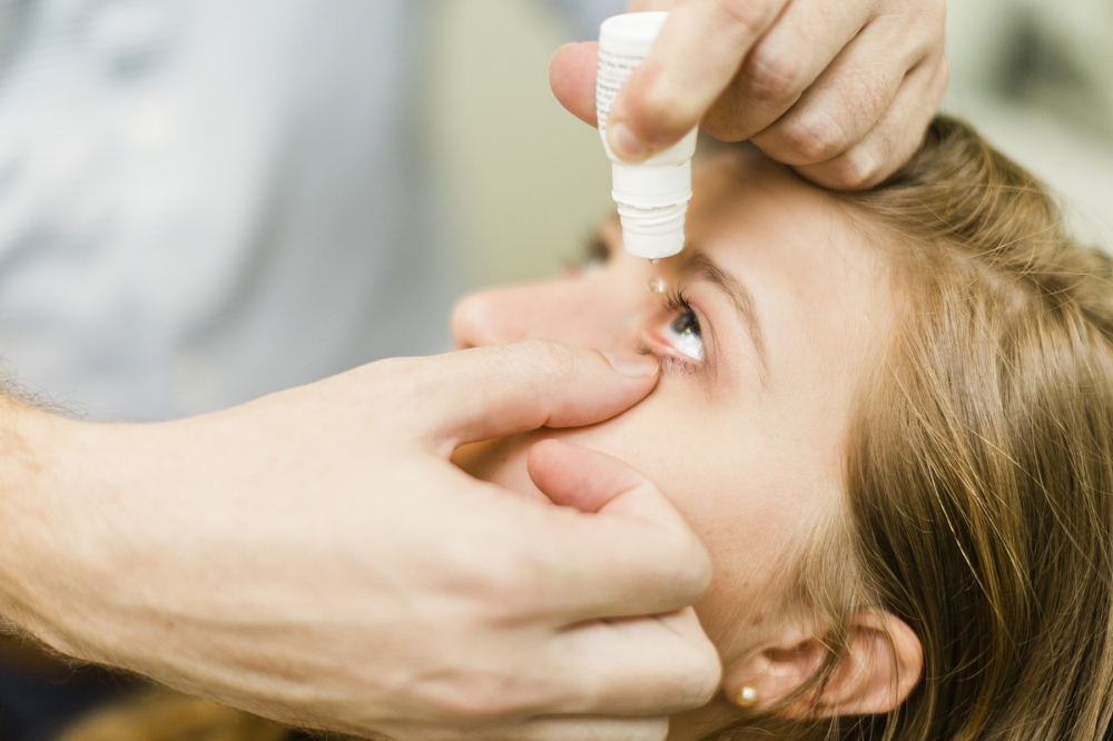 Eye doctor using eye drops